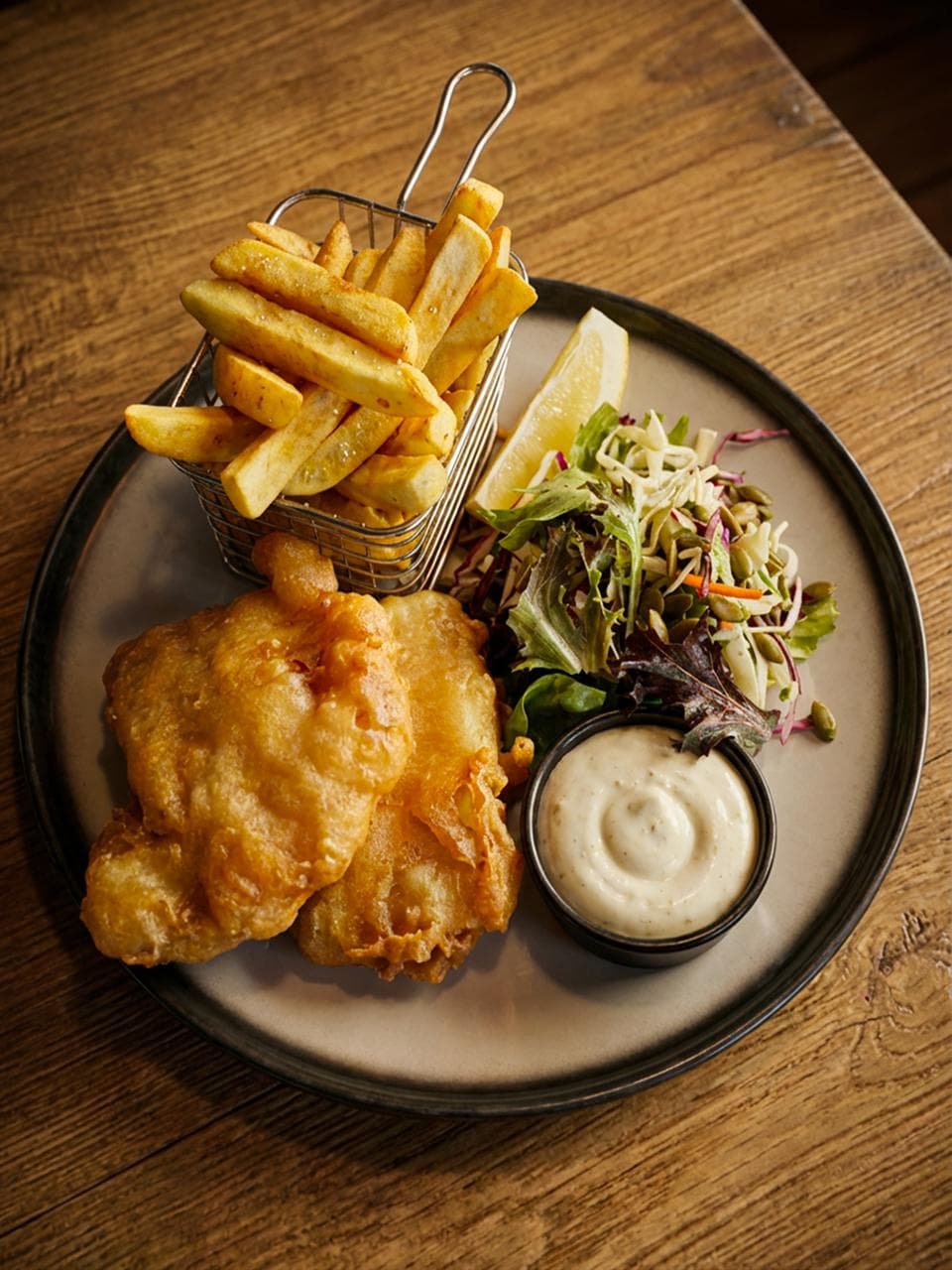 Beer battered fish and chips with tartare sauce at Stampede Bar Papakura
