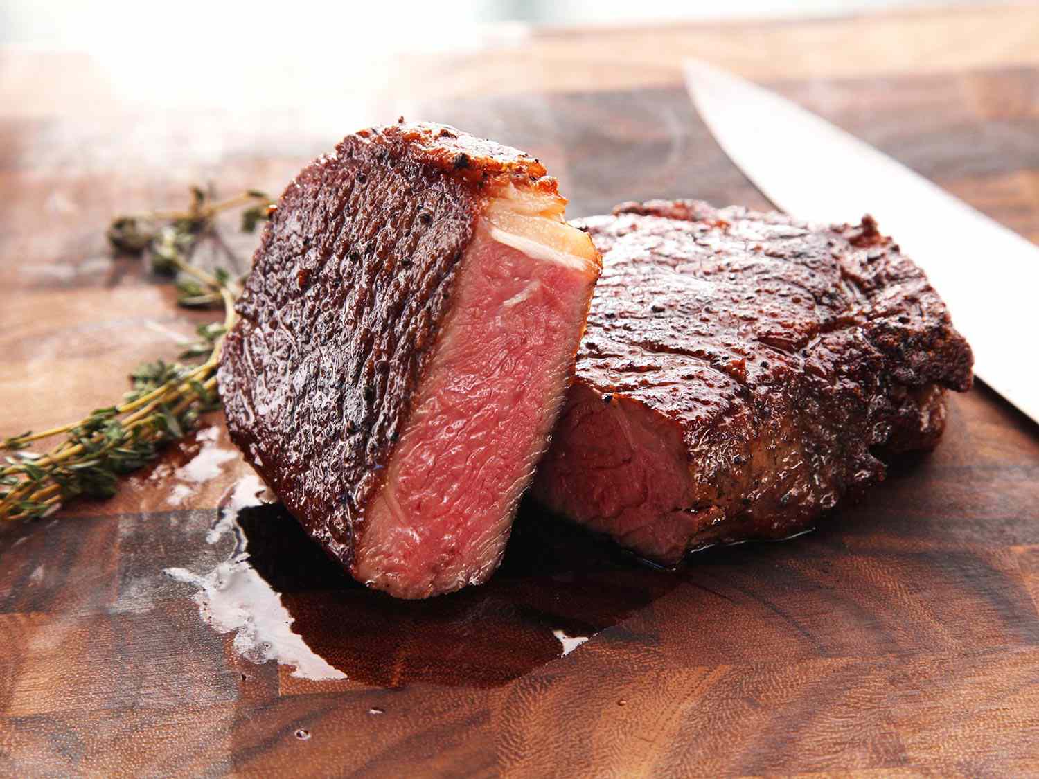 Stonegrill steak cooked medium-rare on a wooden board at Stampede Bar Papakura