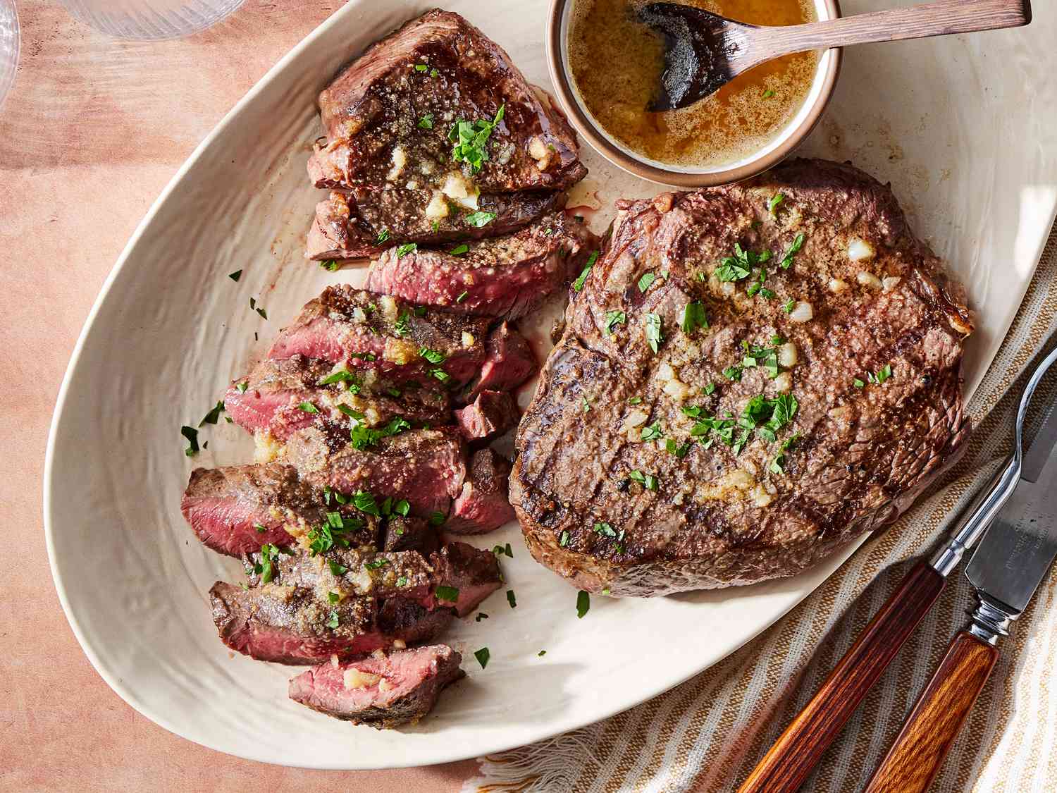 Premium steak platter with garlic butter and herbs at Stampede Bar and Grill